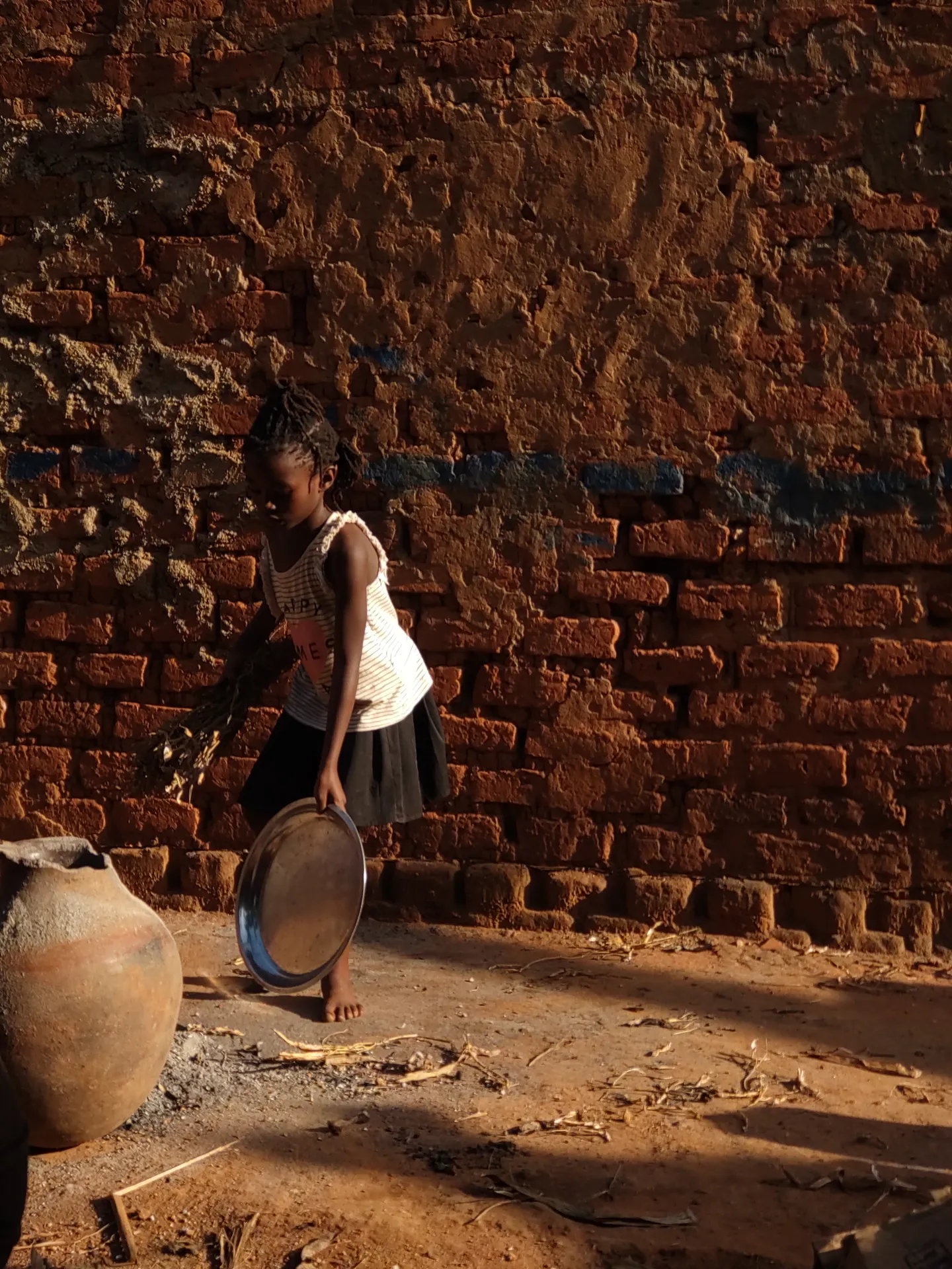Child standing near a community building project