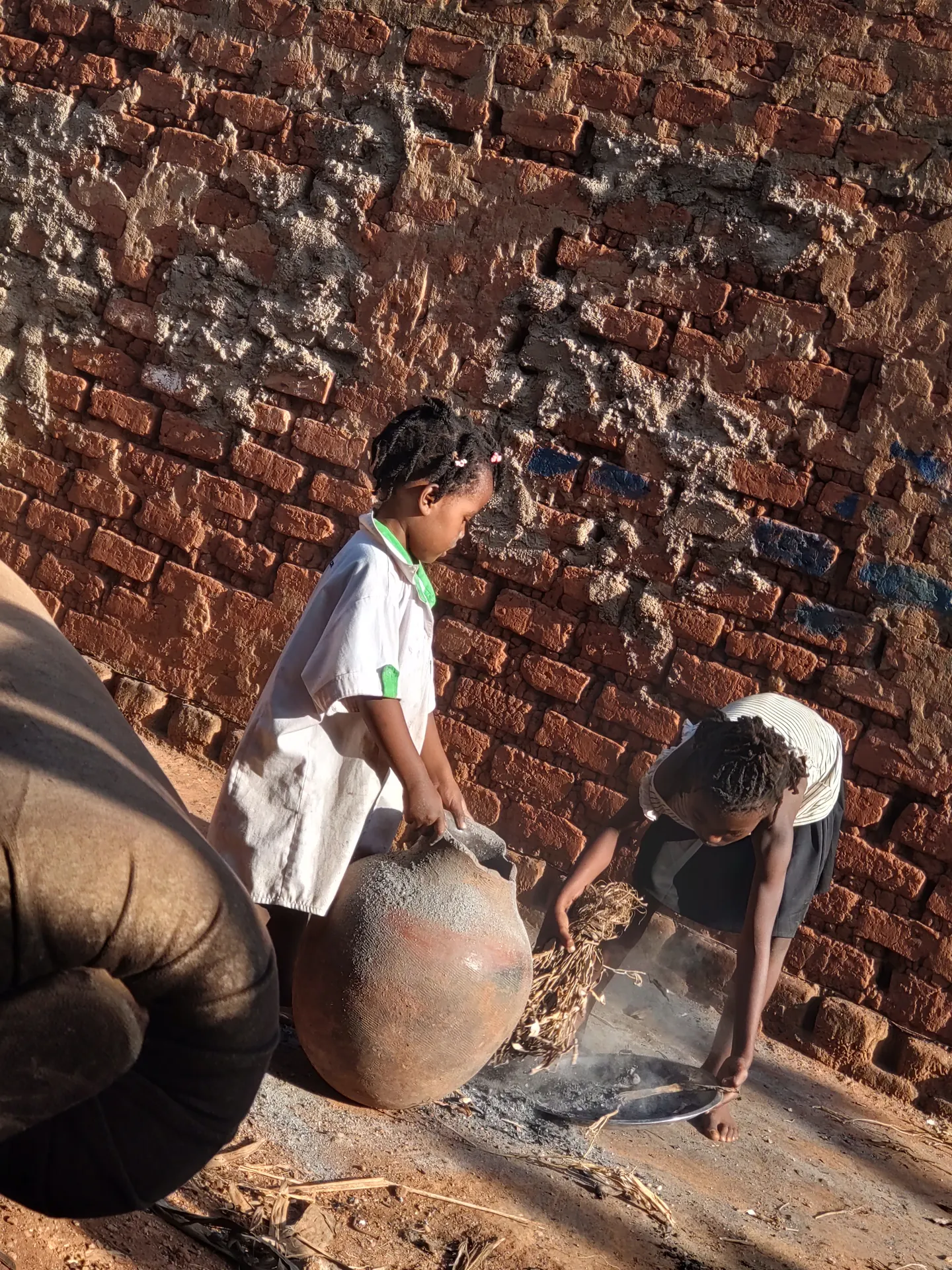 Children beside a community building project