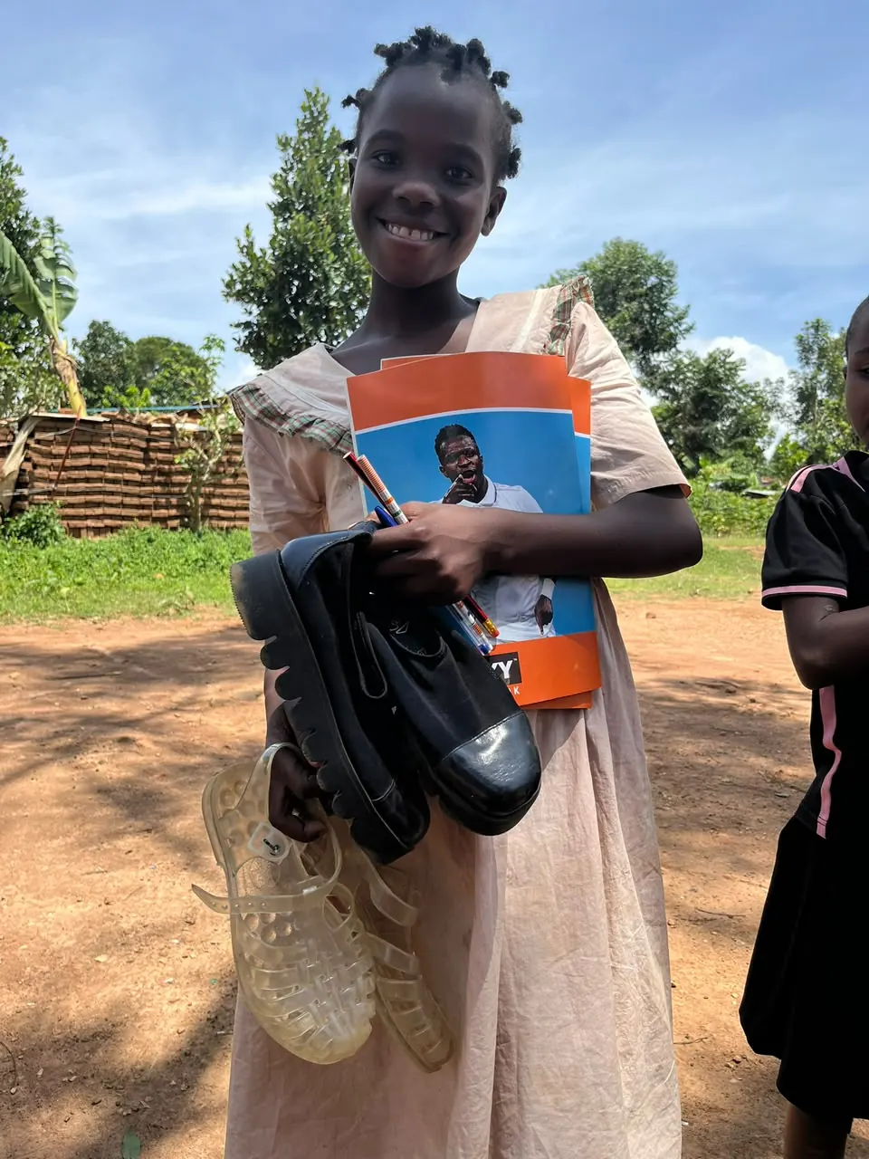 Child with learning support materials in Bumbo