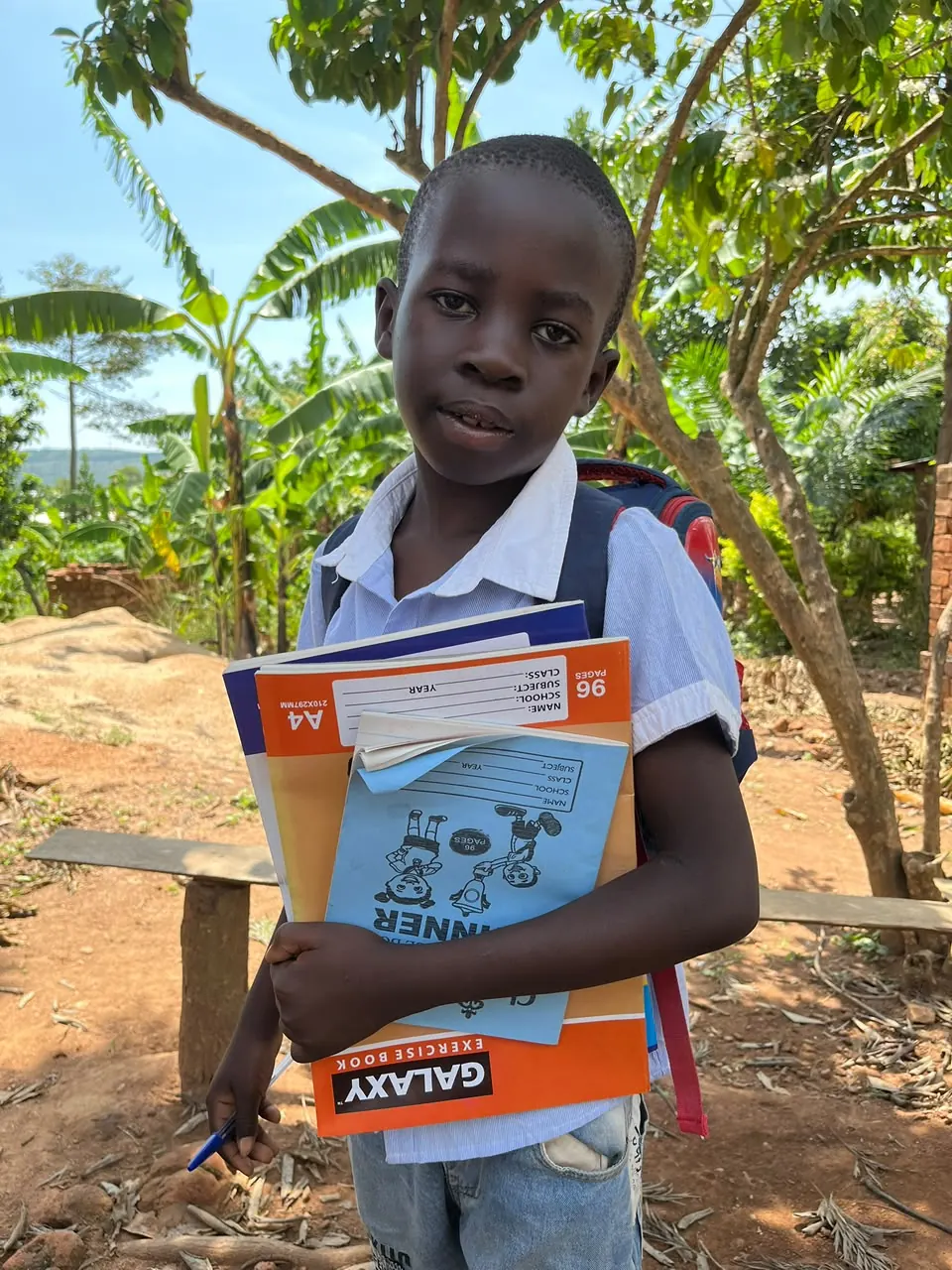 Child holding learning materials during the Bumbo visit